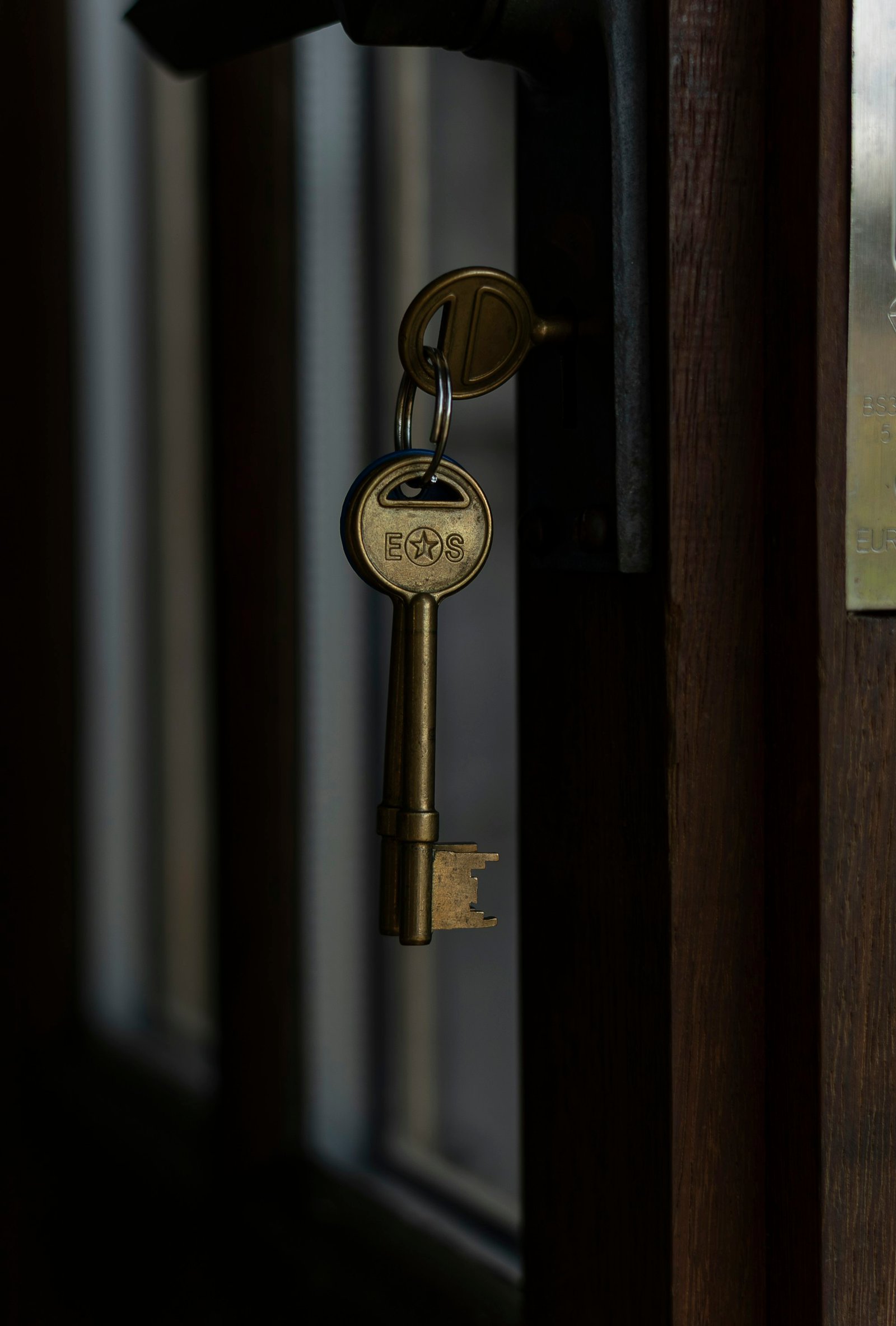 Antique brass keys hanging from a door lock